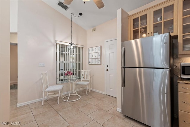 4718 Via Carmen, Naples, FL 34105 - kitchen with stainless steel appliances, a ceiling fan, light tile patterned flooring, glass insert cabinets, and high vaulted ceiling