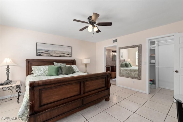 4718 Via Carmen, Naples, FL 34105 - bedroom featuring light tile patterned floors, a walk in closet, ensuite bath, a ceiling fan, and a closet