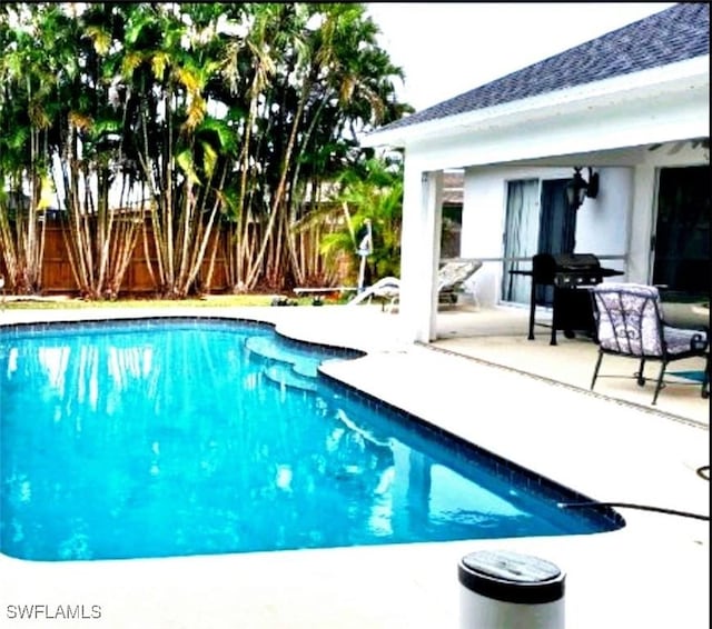 210 NE 9th Place, Cape Coral, FL 33909 - view of swimming pool featuring a patio and grilling area