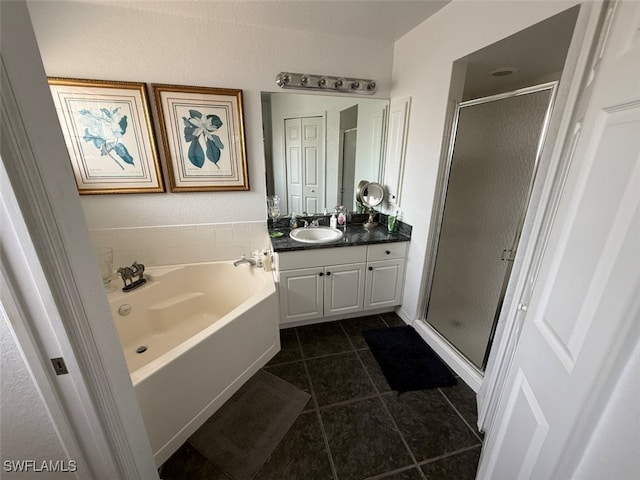 210 NE 9th Place, Cape Coral, FL 33909 - full bathroom with vanity, a stall shower, tile patterned floors, and a garden tub