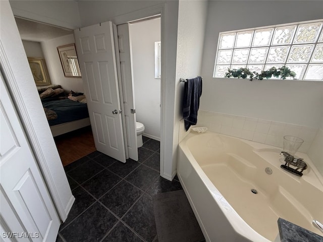 210 NE 9th Place, Cape Coral, FL 33909 - ensuite bathroom featuring a garden tub and tile patterned floors