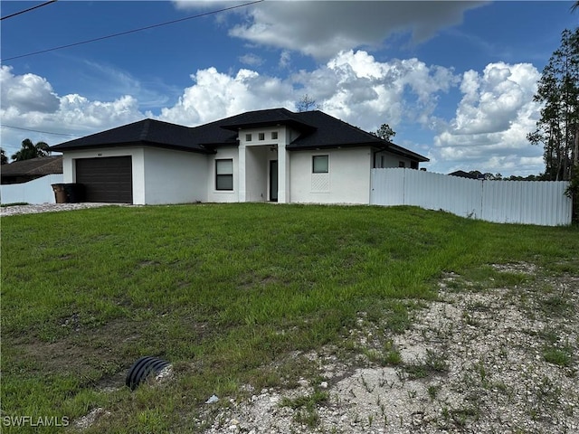 904 James Ave, Lehigh Acres, FL 33936 - prairie-style house with stucco siding and a garage