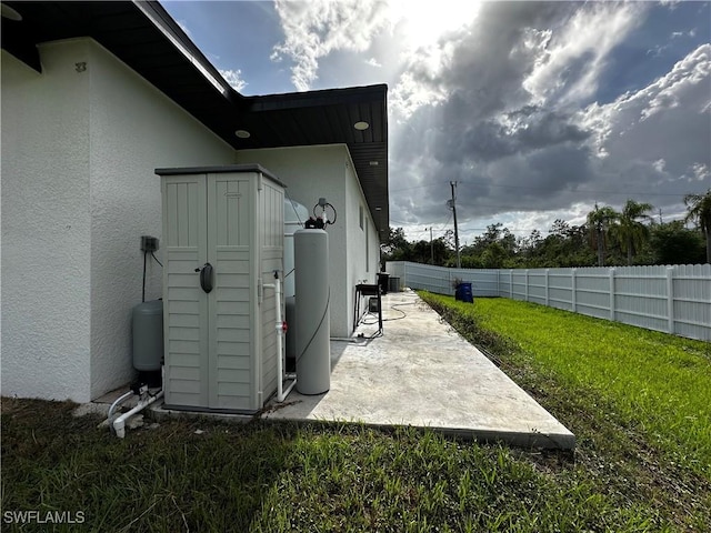 904 James Ave, Lehigh Acres, FL 33936 - view of side of home with stucco siding and a patio