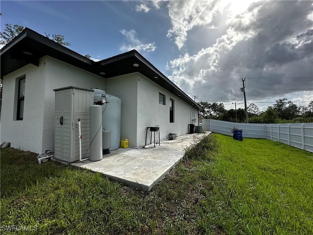 904 James Ave, Lehigh Acres, FL 33936 - back of house featuring stucco siding and a patio area