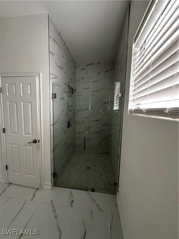 904 James Ave, Lehigh Acres, FL 33936 - bathroom with a marble finish shower and marble look tile flooring