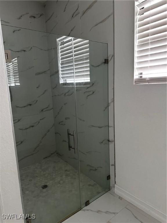 904 James Ave, Lehigh Acres, FL 33936 - bathroom featuring a marble finish shower and marble look tiles