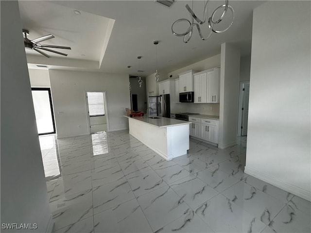 904 James Ave, Lehigh Acres, FL 33936 - kitchen with stainless steel appliances, white cabinetry, a ceiling fan, hanging light fixtures, and a center island with sink