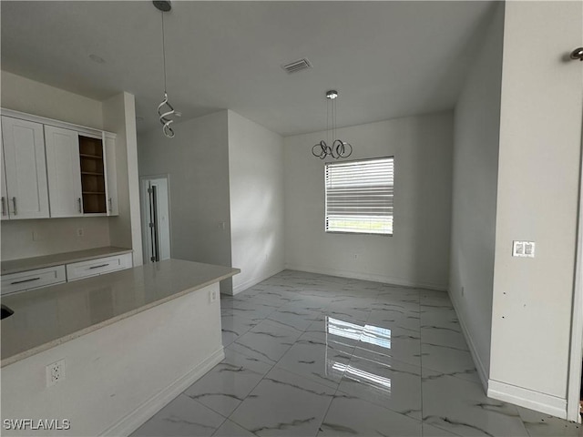 904 James Ave, Lehigh Acres, FL 33936 - kitchen featuring light marble finish flooring, white cabinets, hanging light fixtures, light countertops, and open shelves