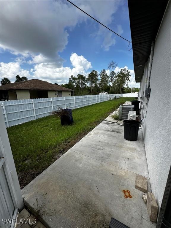 904 James Ave, Lehigh Acres, FL 33936 - fenced backyard featuring a patio area