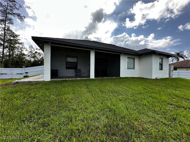 904 James Ave, Lehigh Acres, FL 33936 - back of property featuring stucco siding and a patio area