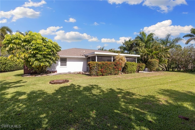 134 Palm River Blvd, Naples, FL 34110 - rear view of house with a yard and a sunroom