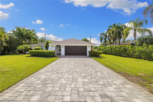 134 Palm River Blvd, Naples, FL 34110 - single story home with a front yard, decorative driveway, a garage, and stucco siding