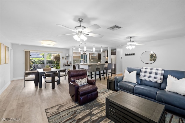 134 Palm River Blvd, Naples, FL 34110 - living room with ceiling fan and light wood finished floors