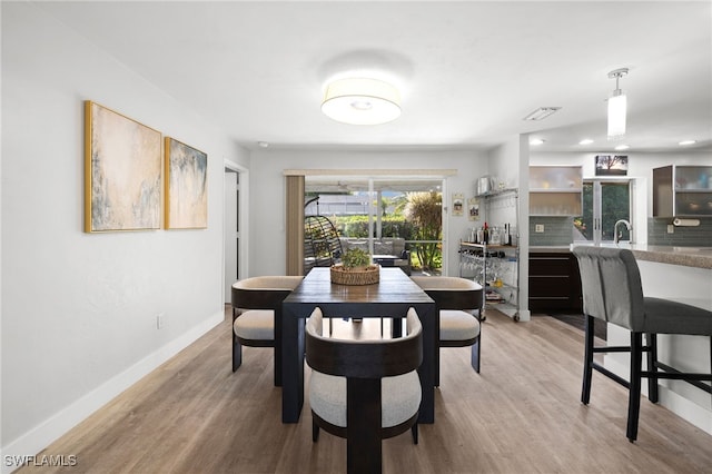 134 Palm River Blvd, Naples, FL 34110 - dining area with light wood-style floors and recessed lighting