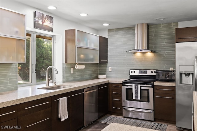 134 Palm River Blvd, Naples, FL 34110 - kitchen featuring appliances with stainless steel finishes, wall chimney range hood, tasteful backsplash, dark brown cabinets, and recessed lighting