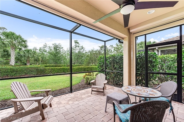 8257 Lucello Ter W, Naples, FL 34114 - sunroom with a ceiling fan and view of wooded area