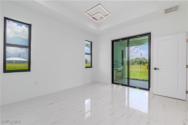 1144 Monday St, Labelle, FL 33935 - unfurnished room featuring healthy amount of natural light, a raised ceiling, and marble tiled flooring