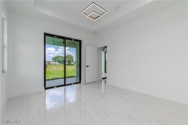 1144 Monday St, Labelle, FL 33935 - spare room with a raised ceiling, marble finish flooring, and a smoke detector