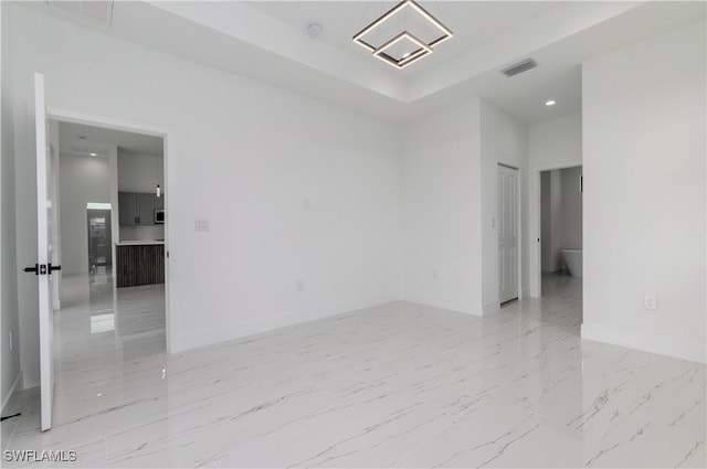 1144 Monday St, Labelle, FL 33935 - empty room with recessed lighting, light marble finish flooring, and a raised ceiling