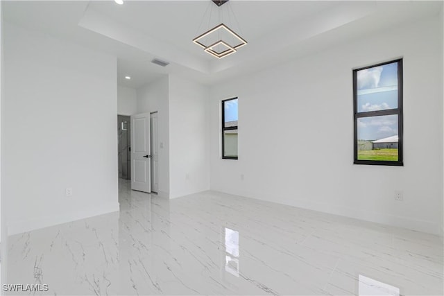 1144 Monday St, Labelle, FL 33935 - spare room with a tray ceiling, recessed lighting, and marble finish flooring