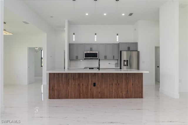 1144 Monday St, Labelle, FL 33935 - kitchen with stainless steel appliances, gray cabinetry, light countertops, a center island with sink, and recessed lighting