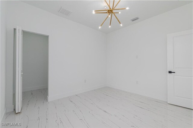 1144 Monday St, Labelle, FL 33935 - empty room with marble look tile flooring and a chandelier