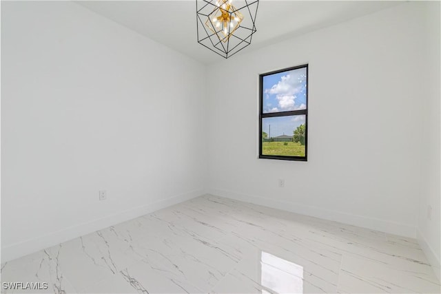 1144 Monday St, Labelle, FL 33935 - spare room featuring marble finish flooring and a chandelier