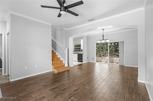 3258 Tamara Dr Unit 2, Naples, FL 34109 - unfurnished living room featuring a ceiling fan, dark wood-style flooring, crown molding, arched walkways, and stairway