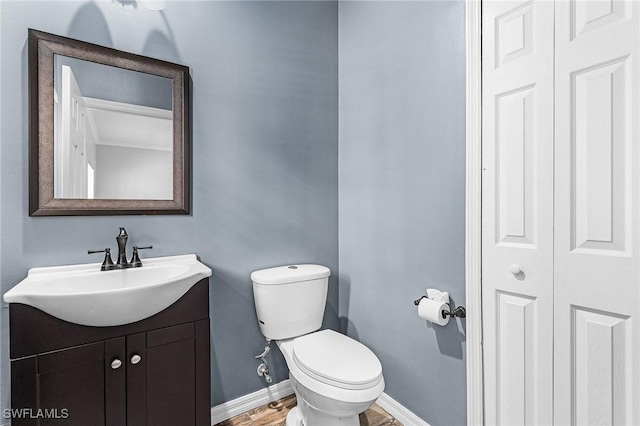 3258 Tamara Dr Unit 2, Naples, FL 34109 - half bath featuring vanity, a closet, and wood finished floors