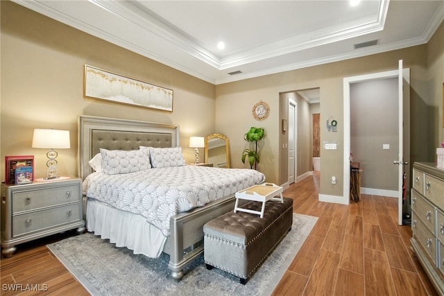 1912 Jung Blvd E, Naples, FL 34120 - bedroom featuring a tray ceiling, wood finished floors, and crown molding