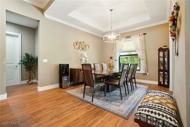 1912 Jung Blvd E, Naples, FL 34120 - dining space featuring a chandelier, wood finished floors, crown molding, and a raised ceiling