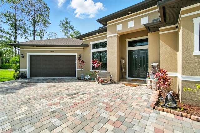 1912 Jung Blvd E, Naples, FL 34120 - entrance to property with stucco siding, decorative driveway, and an attached garage