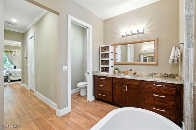 1912 Jung Blvd E, Naples, FL 34120 - ensuite bathroom with a freestanding bath, crown molding, vanity, and wood finished floors
