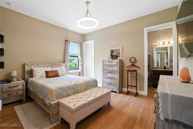 1912 Jung Blvd E, Naples, FL 34120 - bedroom with light wood-style flooring and connected bathroom