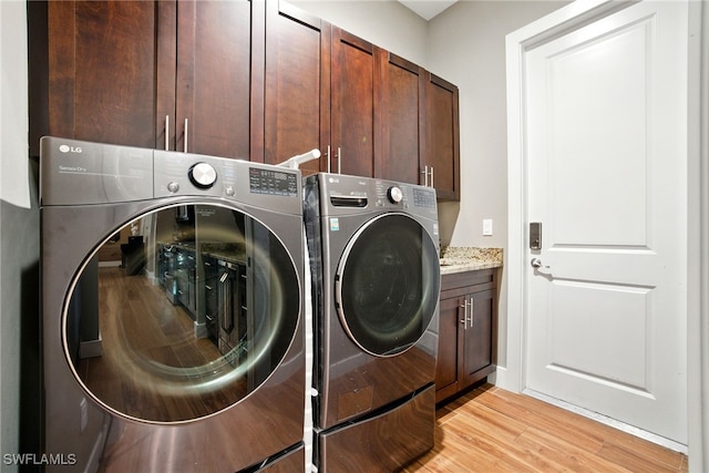 1912 Jung Blvd E, Naples, FL 34120 - washroom featuring washing machine and clothes dryer, cabinet space, and light wood-style flooring