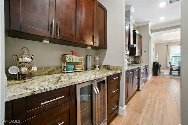 1912 Jung Blvd E, Naples, FL 34120 - kitchen featuring double oven range, ornamental molding, wine cooler, light stone counters, and light wood-style flooring