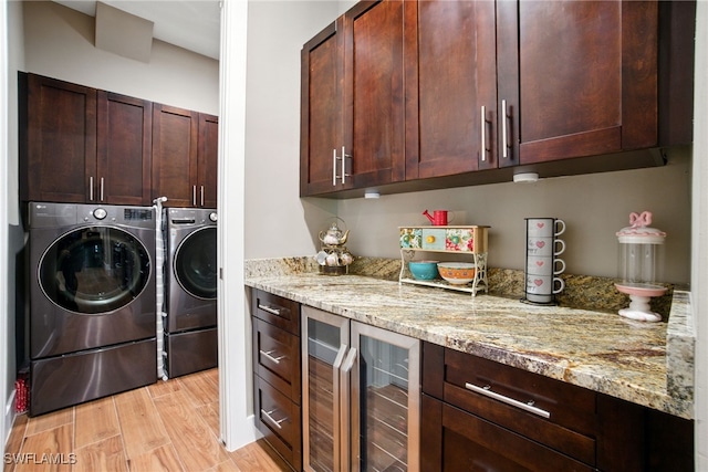 1912 Jung Blvd E, Naples, FL 34120 - washroom with beverage cooler, washing machine and dryer, cabinet space, and light wood-type flooring