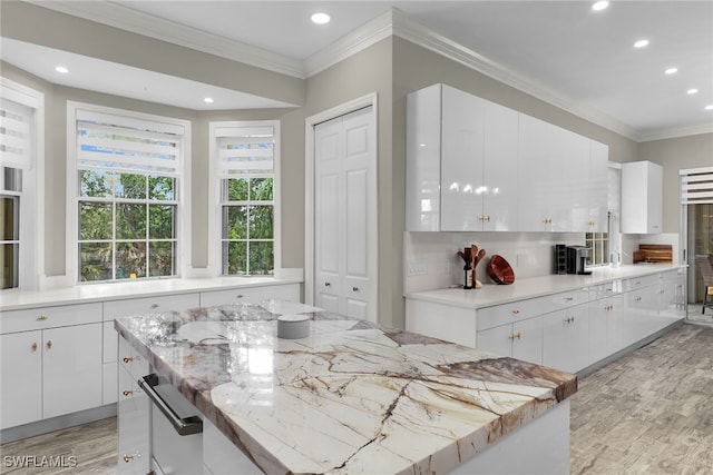 5040 Yacht Harbor Cir Unit 6, Naples, FL 34112 - kitchen featuring recessed lighting, light wood finished floors, crown molding, white cabinetry, and light stone counters