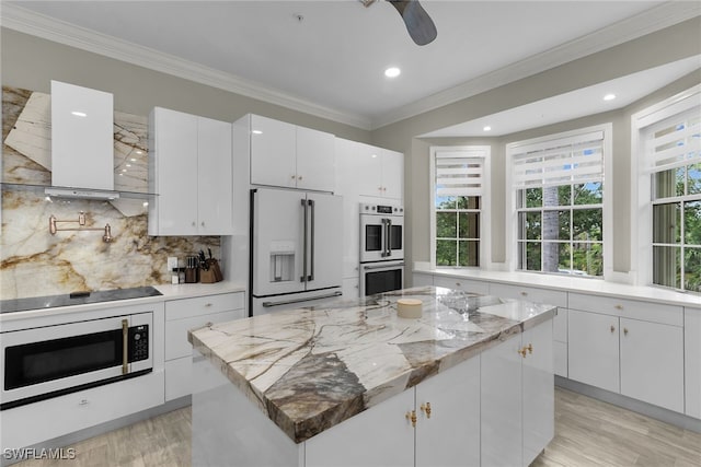 5040 Yacht Harbor Cir Unit 6, Naples, FL 34112 - kitchen featuring white appliances, extractor fan, light wood-style floors, ornamental molding, and decorative backsplash