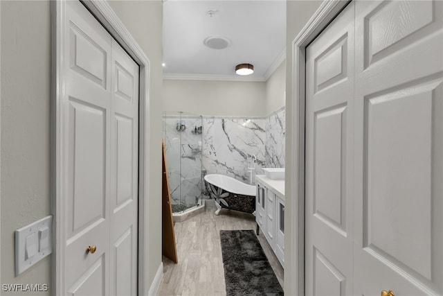 5040 Yacht Harbor Cir Unit 6, Naples, FL 34112 - full bath featuring a marble finish shower, tile walls, crown molding, vanity, and wood finished floors
