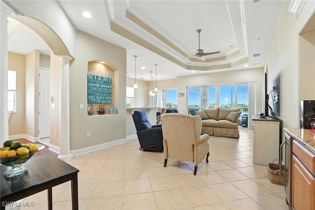 178 Shadroe Cove Cir Unit 903, Cape Coral, FL 33991 - living area featuring ornate columns, a ceiling fan, a raised ceiling, arched walkways, and crown molding