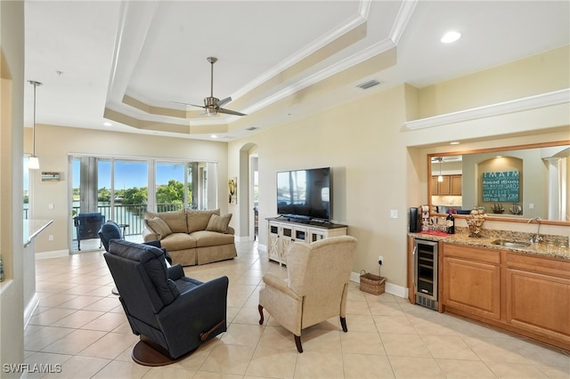 178 Shadroe Cove Cir Unit 903, Cape Coral, FL 33991 - living room featuring wine cooler, a raised ceiling, ornamental molding, light tile patterned flooring, and a ceiling fan