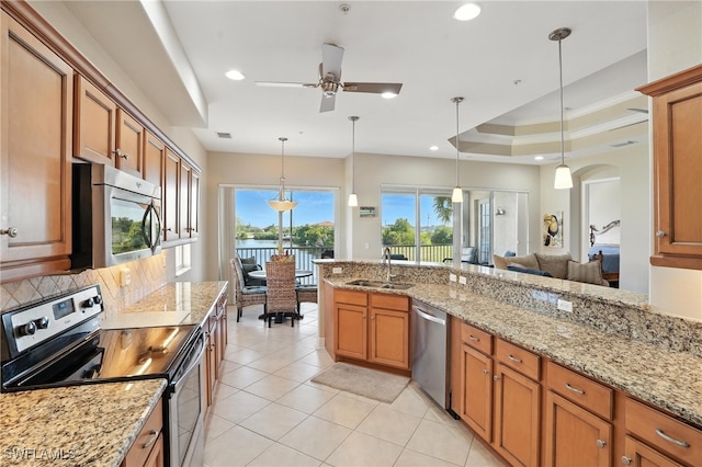 178 Shadroe Cove Cir Unit 903, Cape Coral, FL 33991 - kitchen with appliances with stainless steel finishes, brown cabinets, ceiling fan, light tile patterned floors, and recessed lighting