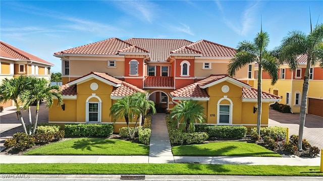 178 Shadroe Cove Cir Unit 903, Cape Coral, FL 33991 - mediterranean / spanish house featuring a tile roof, stucco siding, and a front yard
