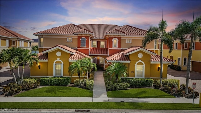 178 Shadroe Cove Cir Unit 903, Cape Coral, FL 33991 - mediterranean / spanish house featuring a tiled roof, a front lawn, and stucco siding