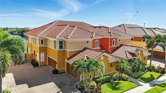 178 Shadroe Cove Cir Unit 903, Cape Coral, FL 33991 - mediterranean / spanish home with stucco siding, an attached garage, a tile roof, and driveway