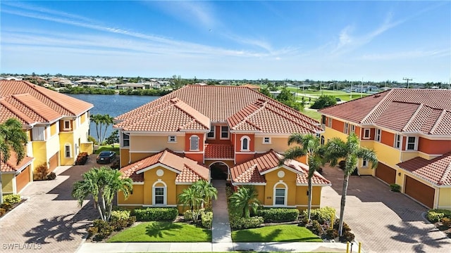178 Shadroe Cove Cir Unit 903, Cape Coral, FL 33991 - mediterranean / spanish-style house with driveway, a tile roof, stucco siding, a garage, and a residential view