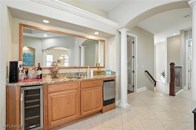 178 Shadroe Cove Cir Unit 903, Cape Coral, FL 33991 - indoor wet bar with wine cooler, decorative columns, arched walkways, recessed lighting, and light tile patterned floors