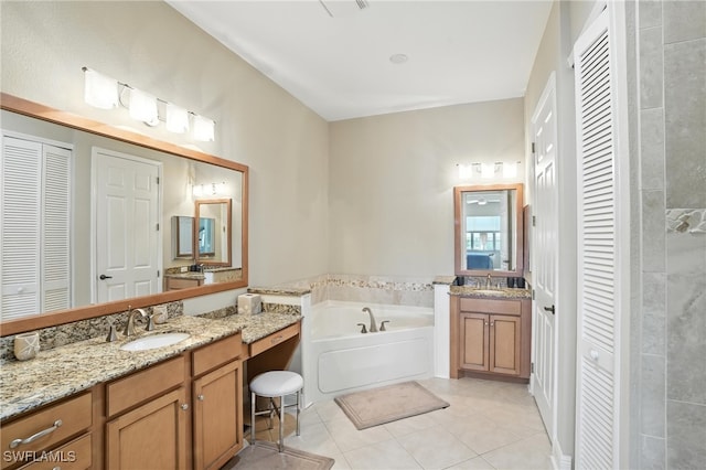 178 Shadroe Cove Cir Unit 903, Cape Coral, FL 33991 - bathroom with a closet, tile patterned flooring, a bath, and two vanities