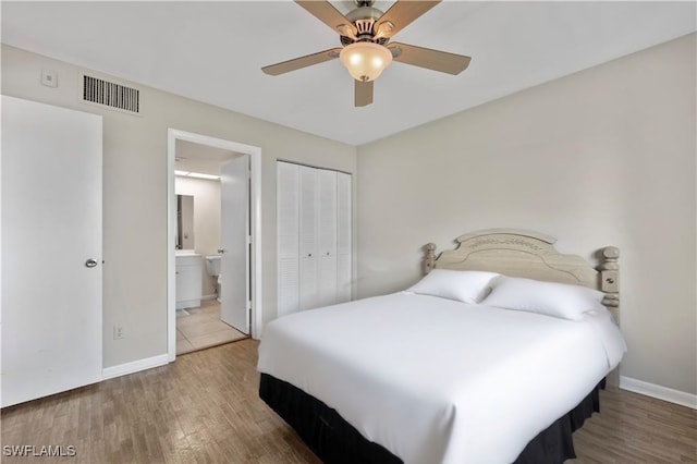 1018 Manatee Rd Unit E302, Naples, FL 34114 - bedroom featuring wood finished floors, a closet, ensuite bath, and a ceiling fan